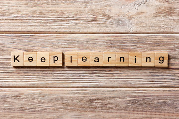 keep learning word written on wood block. keep learning text on table, concept