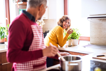 Senior couple preparing food in the kitchen.