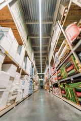 blurred view of shelves with boxes in storehouse