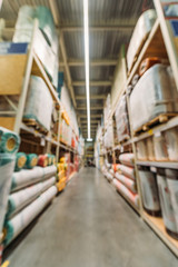 blurred view of shelves with boxes in storehouse