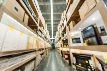 blurred view of shelves with boxes in warehouse