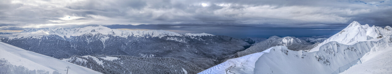 Fototapeta na wymiar Against the background of the Black Sea, snow-capped mountains. Sochi, Russia