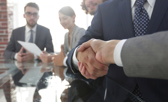 handshake of business partners in conference room