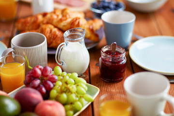jar with jam on wooden table at breakfast