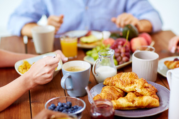 close up of people eating food at table