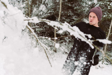 Fototapeta premium Young man shadow boxing in a forrest in Austria in the winter