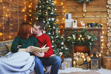 Young happy funny family near christmas tree