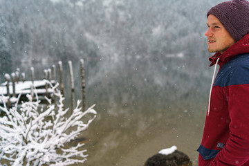 Fototapeta na wymiar Young man standing on a lake in Austria in the winter