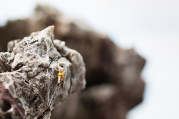 Miniature people : Women are playing high climbing sport. Used as a background for holiday adventure travel business concept.