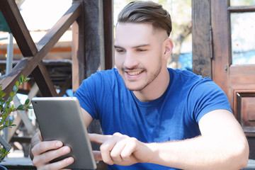 Young latin man using a tablet