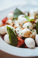 tasty salad with mozzarella, tomatoes and arugula