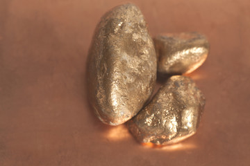 Golden nuggets on a copper background