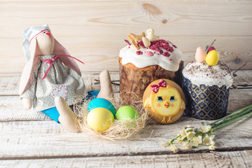 Festive table with cake and colorful eggs on wooden background. Concept of Orthodox Easter