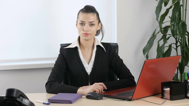 No by shaking head, gesture by young attractive girl in office. 60 fps