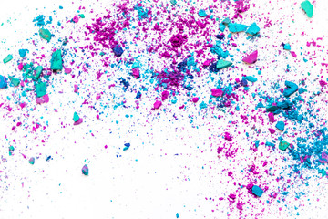 makeup trends. Samples of dry blush, powder, bronzers and highlighter scattered on a white background. purple, blue, gray broken on the table