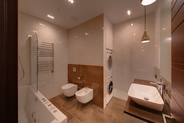 A light bathroom with washing and drying cars and light walls