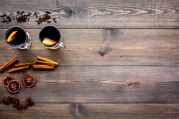 Ingredients for mulled wine. Spices cinnamon and badian, citrus fruits on dark wooden background top view copyspace