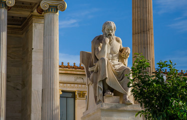 Ancient statue of the great Greek philosopher Socrates on background of classical columns. 