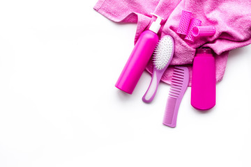 Basic hair care in bathroom. Comb, shampoo, spray, towel on white background top view copyspace