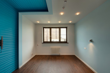 The room with blue walls and a wooden dark window