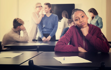 sad girl student feeling uncomfortable at break between classes