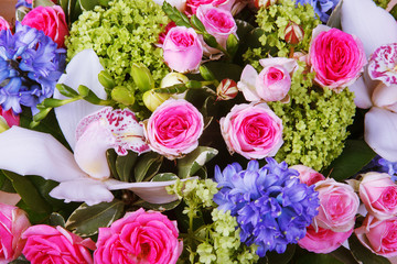 A bouquet of flowers, roses, hyacinths, orchids. Background of flowers