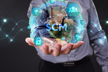 The concept of business, technology, the Internet and the network. A young entrepreneur working on a virtual screen of the future and sees the inscription: SCM