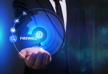 Business, Technology, Internet and network concept. Young businessman working on a virtual screen of the future and sees the inscription: Firewall