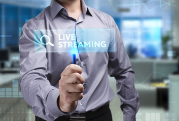 The concept of business, technology, the Internet and the network. A young entrepreneur working on a virtual screen of the future and sees the inscription: Live streaming