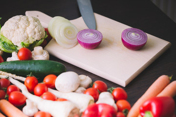 Red onion on wooden board.