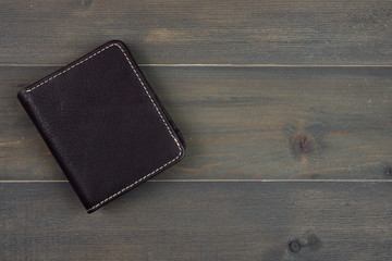 leather wallet on wood background