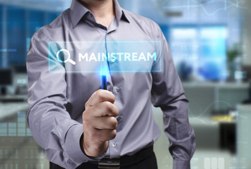 The concept of business, technology, the Internet and the network. A young entrepreneur working on a virtual screen of the future and sees the inscription: Mainstream