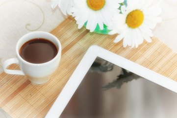 morning coffee and a tablet at breakfast, chamomile in a vase on the table, filter applied