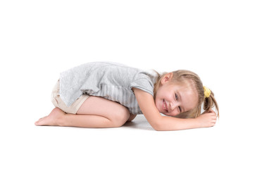 Little girl lies on studio floor