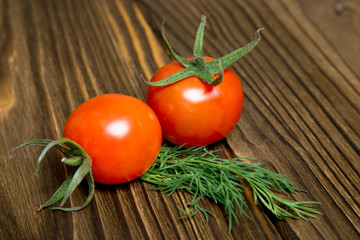 Ripe tomatoes on dark wooden background