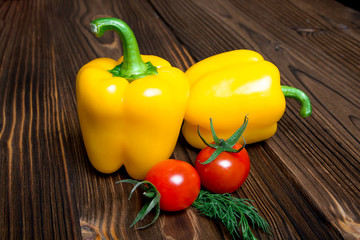 Paprika tomato green onion background - summer garden harvest. Red, yellow and yellow pepper, tomatoes, red onion,