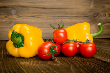Paprika tomato green onion background - summer garden harvest. Red, yellow and yellow pepper, tomatoes, red onion,