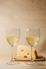cheese, grapes and two glasses of the white wine