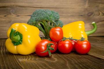 Paprika tomato green onion background - summer garden harvest. Red, yellow and yellow pepper, tomatoes, red onion,