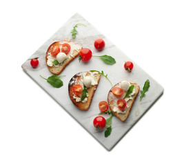 Board with delicious tomato and mozzarella sandwiches on white background