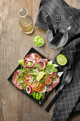 Fototapeta na wymiar Plate with delicious fresh salad on table