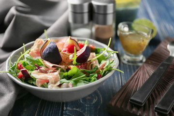 Bowl with delicious fresh salad on table
