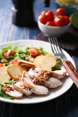 Plate with meat and delicious fresh salad on table