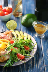 Plate with meat and delicious fresh salad on table