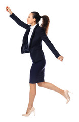 Young woman in formal clothes running against white background