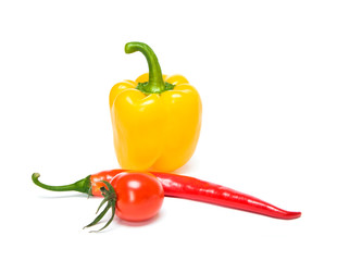 Several beautiful ripe sweet and hot peppers of red and orange on a white background