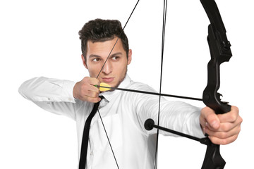 Young businessman practicing archery on white background