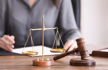 Scales of justice and judge hammer on table in notary's office