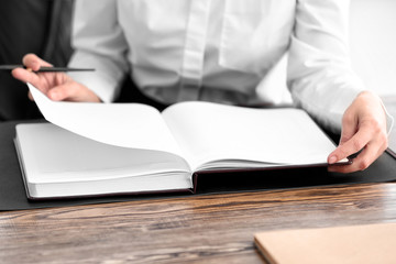 Female notary with notebook in office, closeup