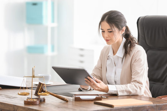 Young female notary working in office